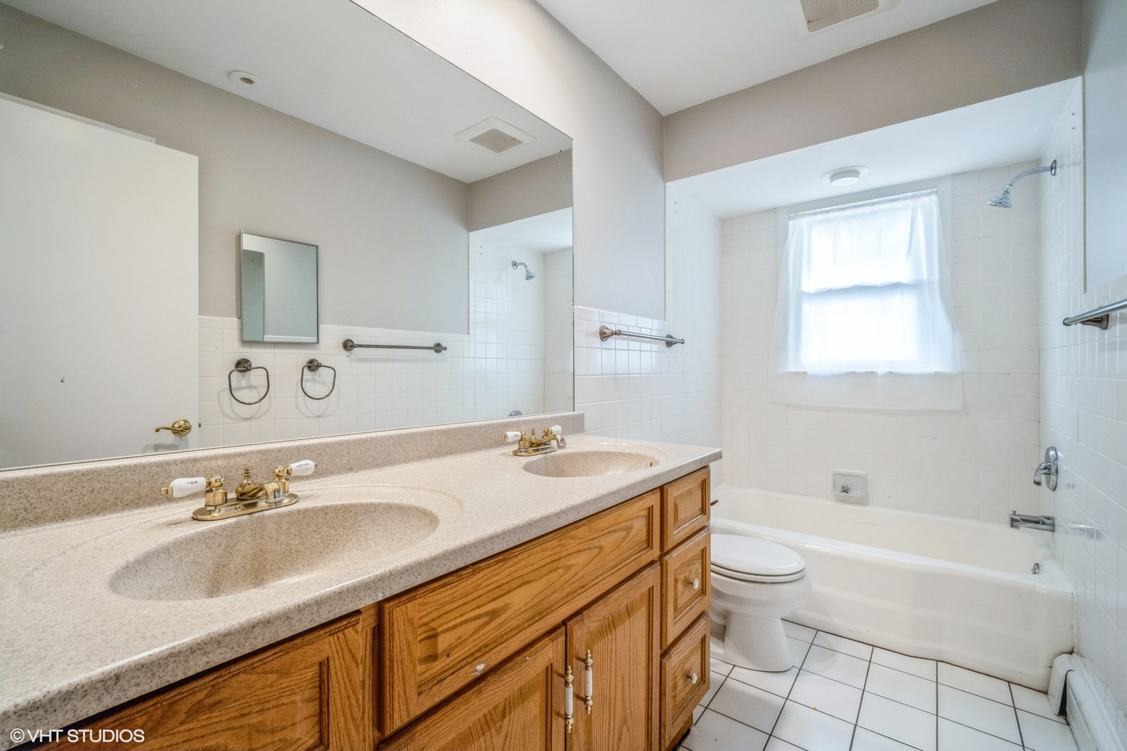 1644 Pfingsten Road Northbrook, IL 60062 - Photo 15 of 17 a bathroom with a granite countertop sink a toilet a mirror and bathtub
