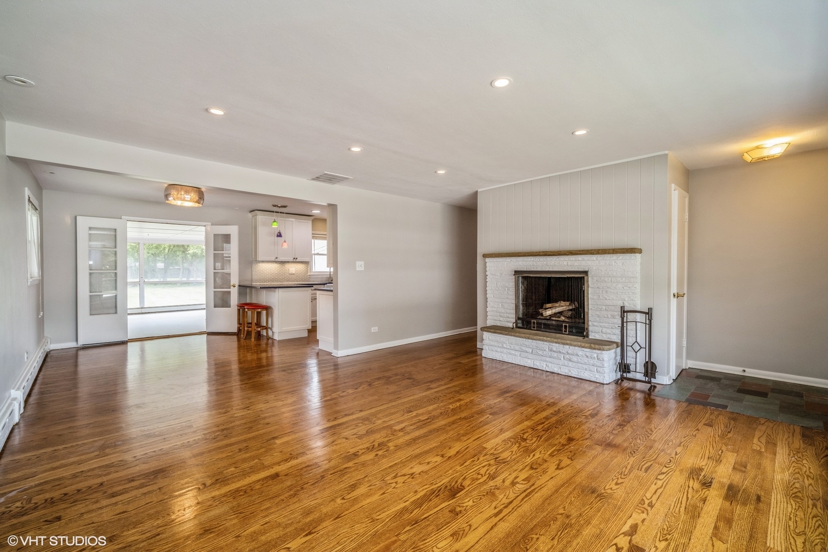 1644 Pfingsten Road Northbrook, IL 60062 - Photo 6 of 17 a view of empty room with wooden floor and fireplace