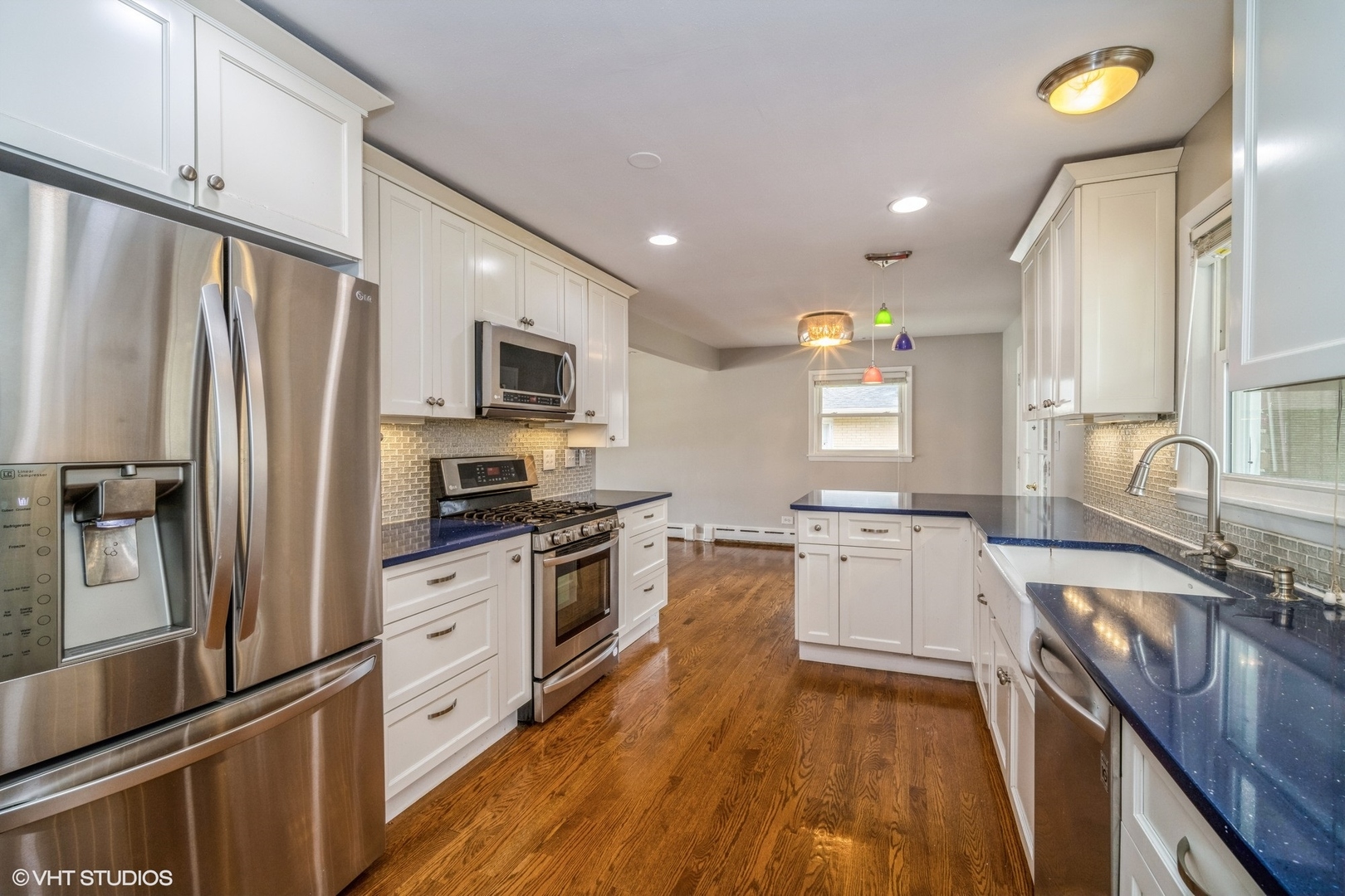 1644 Pfingsten Road Northbrook, IL 60062 - Photo 7 of 17 a kitchen with granite countertop a refrigerator a sink dishwasher and a stove top oven with wooden floor