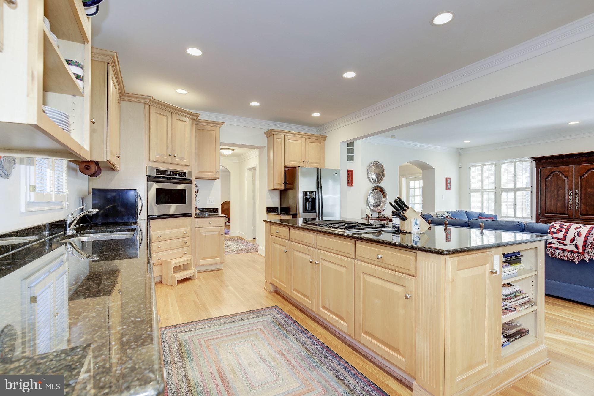 5220 Elliott Road Bethesda, MD 20816 - Photo 13 of 30 a kitchen with stainless steel appliances granite countertop a stove top oven a sink a dining table and chairs