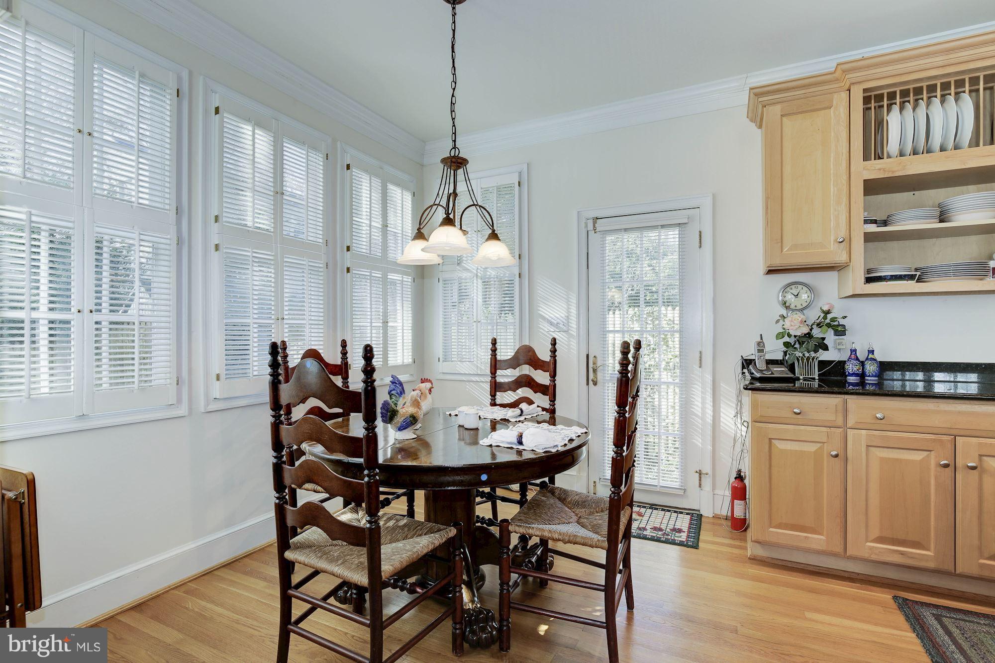 5220 Elliott Road Bethesda, MD 20816 - Photo 14 of 30 a view of a dining room with furniture and wooden floor