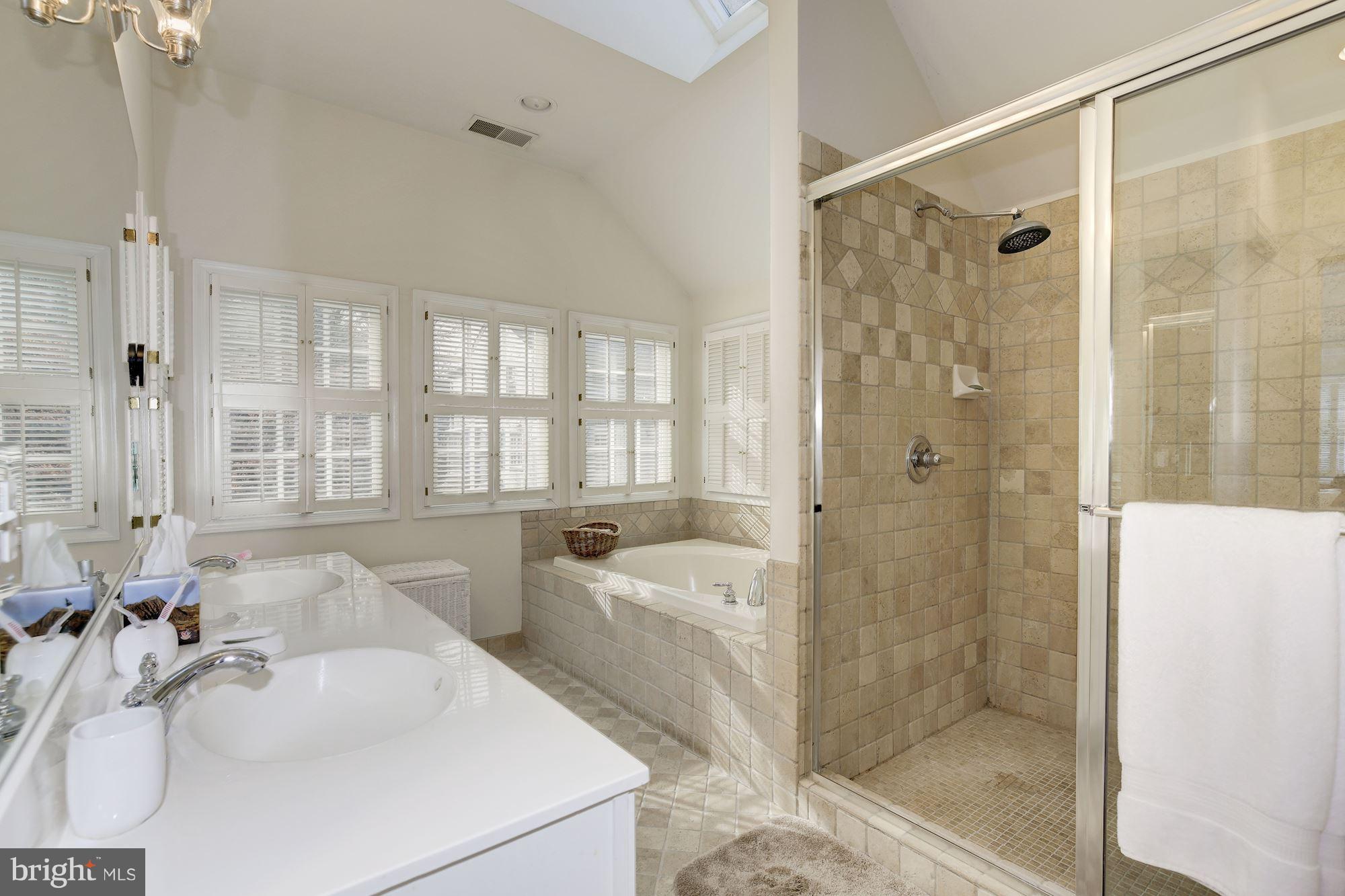 5220 Elliott Road Bethesda, MD 20816 - Photo 18 of 30 a spacious bathroom with a tub shower and sink
