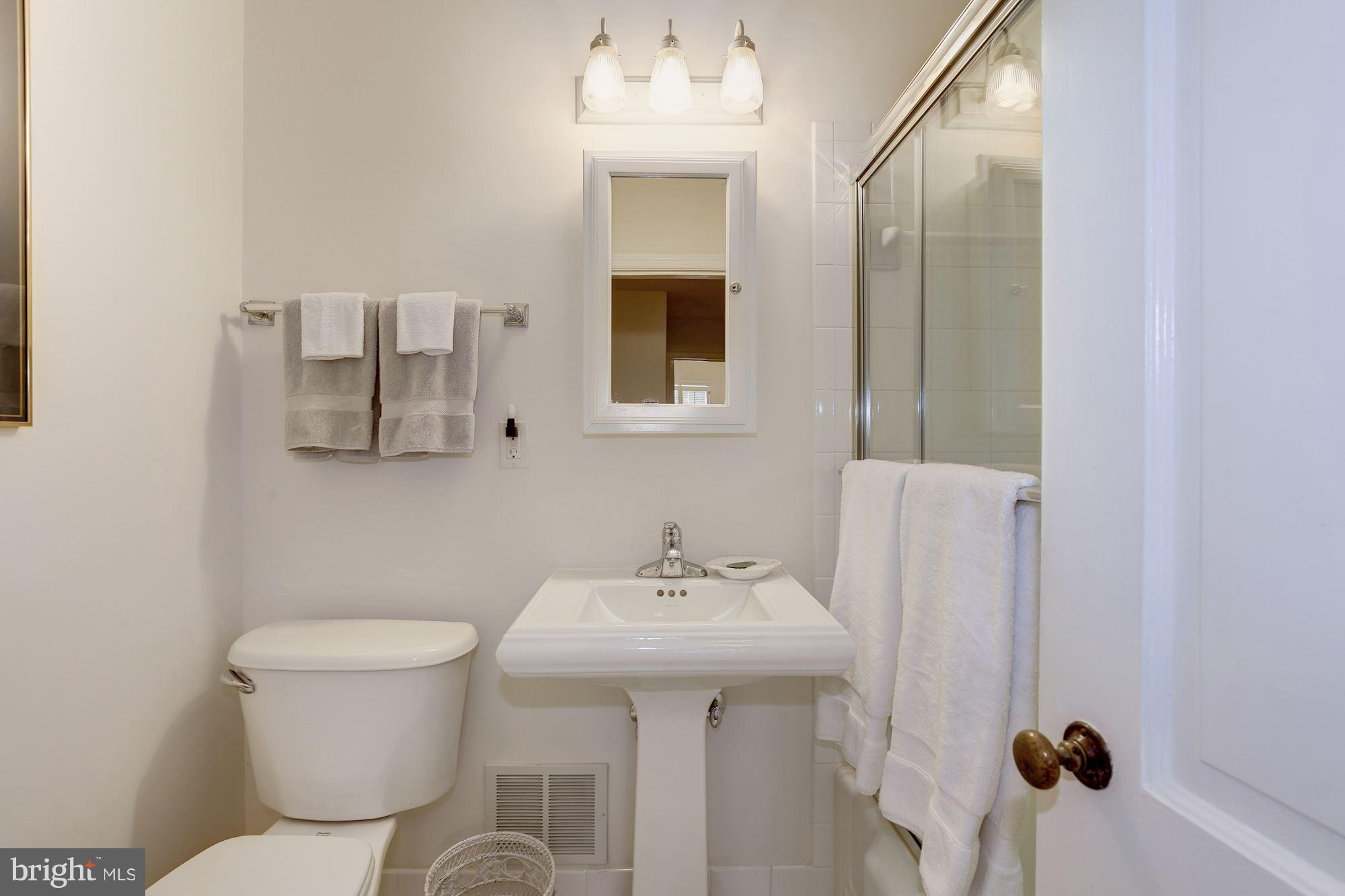 5220 Elliott Road Bethesda, MD 20816 - Photo 20 of 30 a bathroom with a sink mirror and toilet