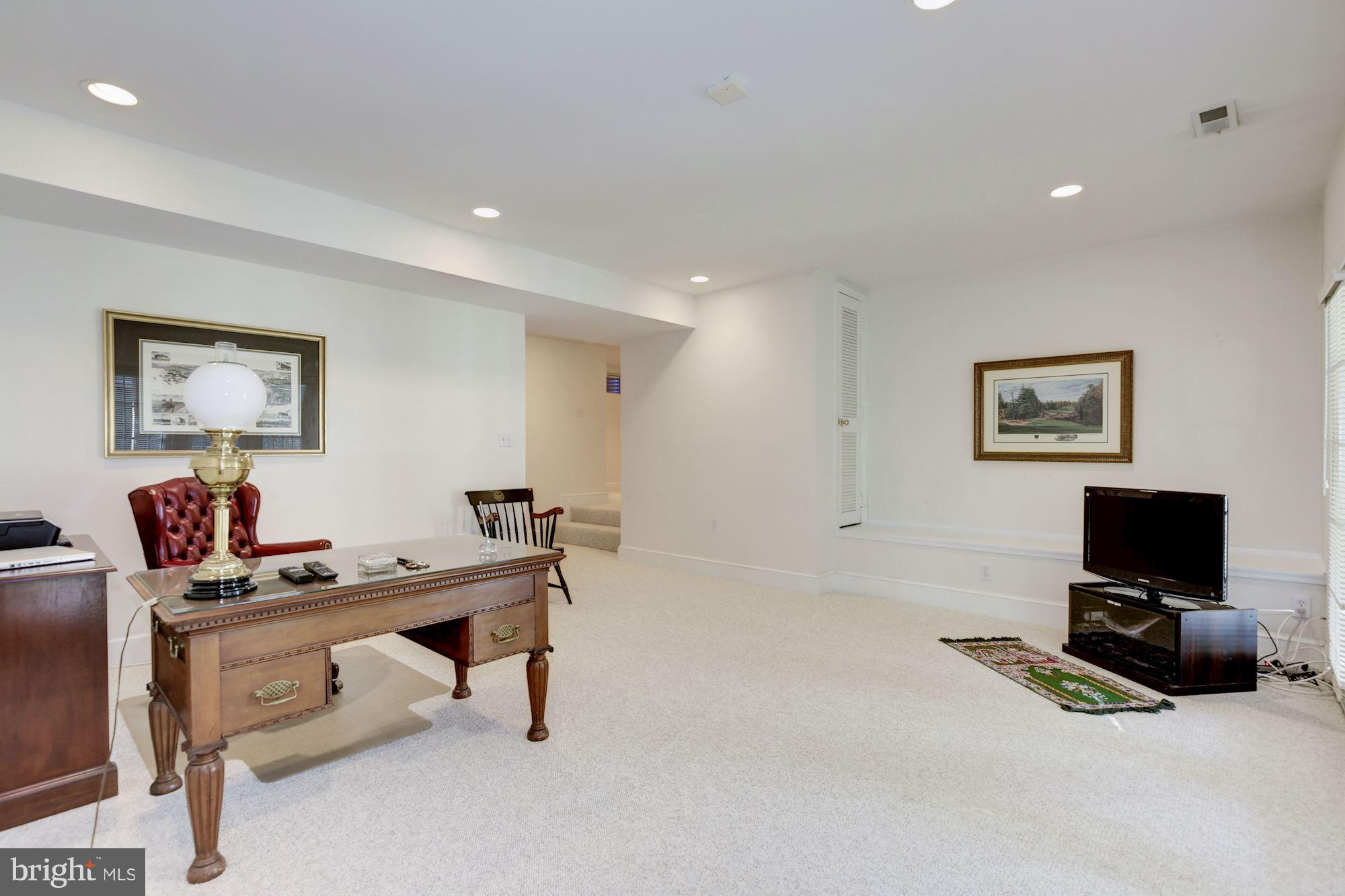 5220 Elliott Road Bethesda, MD 20816 - Photo 25 of 30 a living room with furniture and a flat screen tv