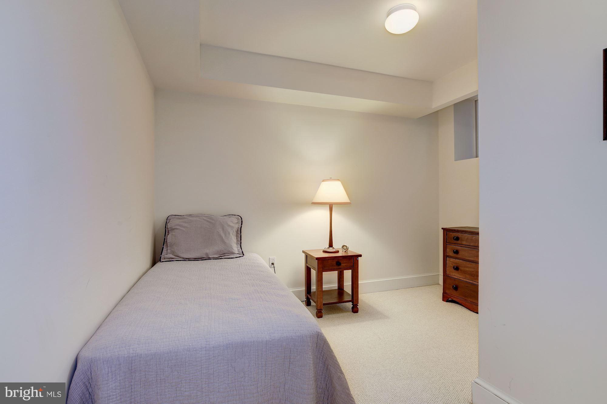 5220 Elliott Road Bethesda, MD 20816 - Photo 27 of 30 a bed room with a bed and a lamp