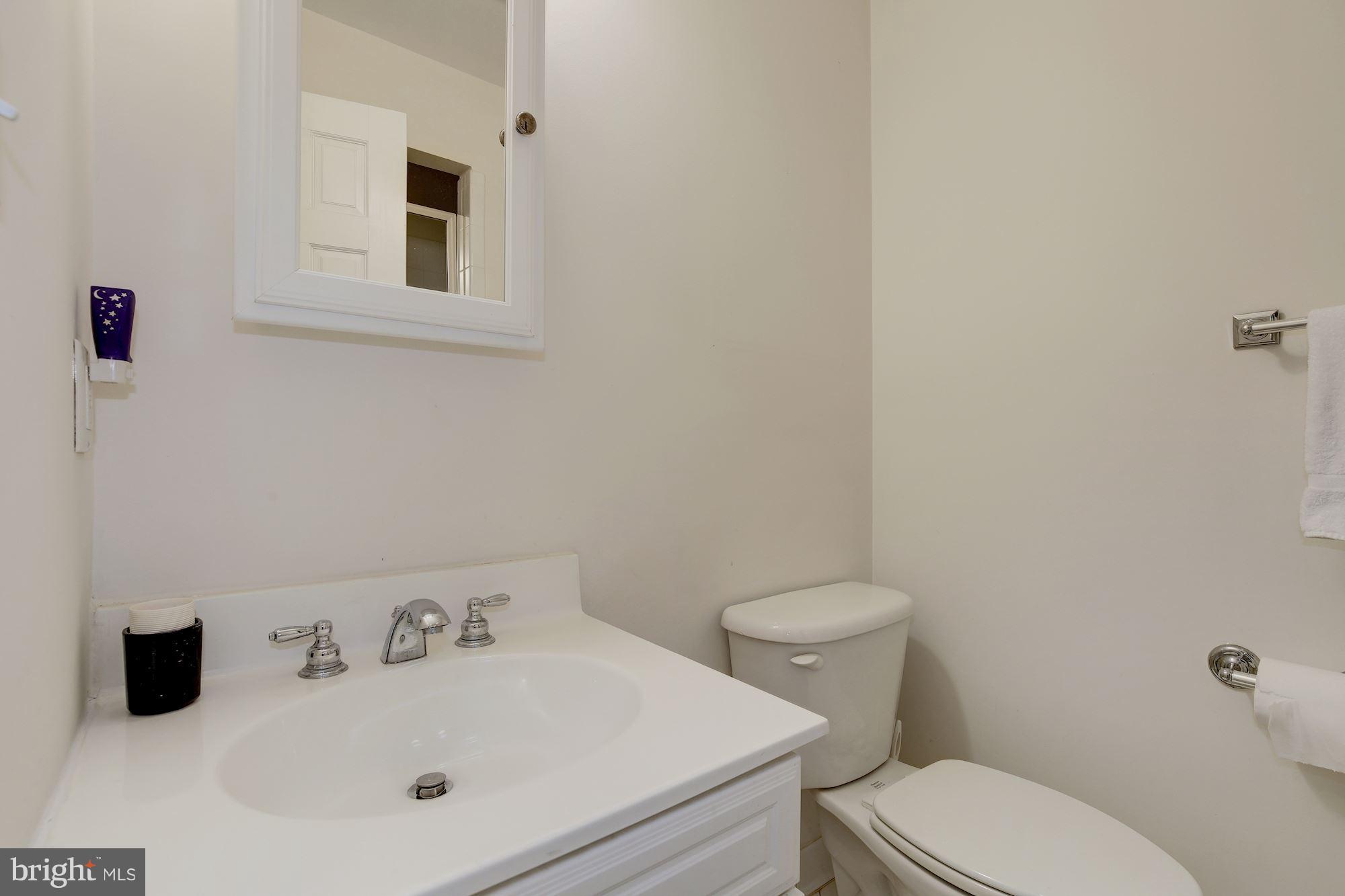 5220 Elliott Road Bethesda, MD 20816 - Photo 28 of 30 a white toilet sitting next to a bathroom sink