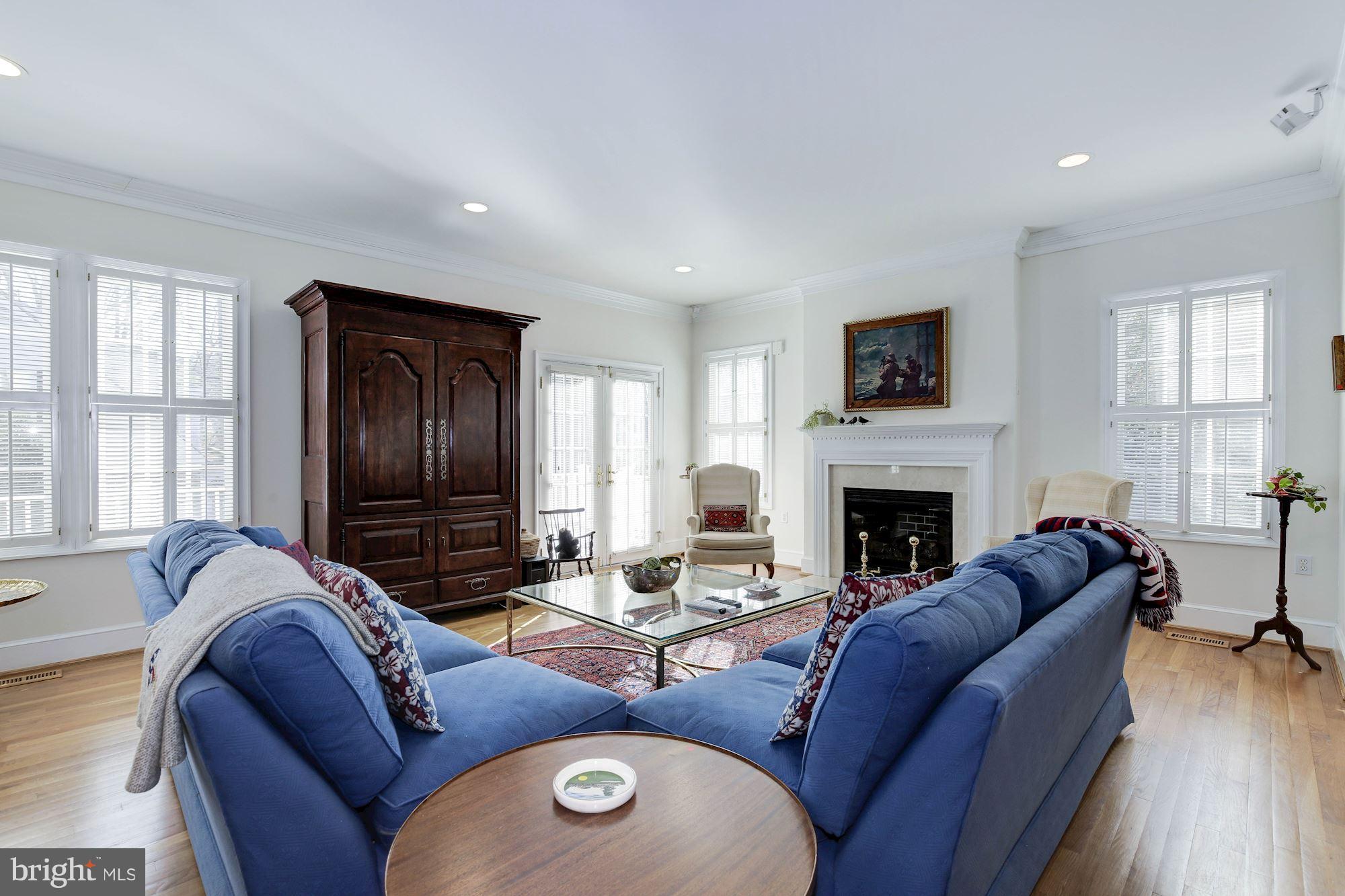 5220 Elliott Road Bethesda, MD 20816 - Photo 6 of 30 a living room with furniture fireplace and a flat screen tv