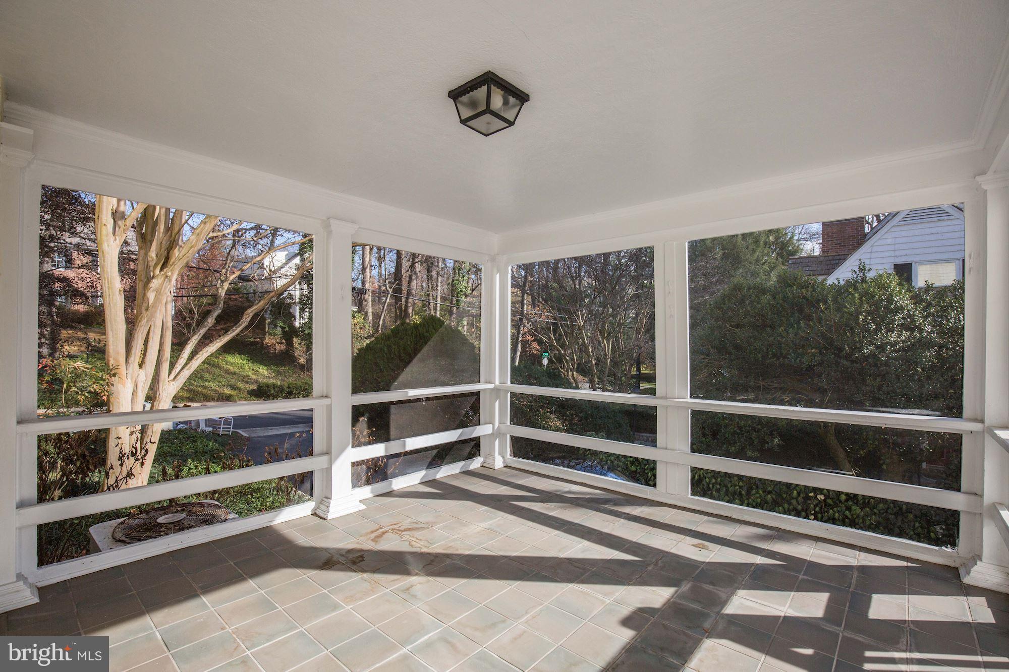 5220 Elliott Road Bethesda, MD 20816 - Photo 10 of 30 a view of a porch with wooden floor and windows