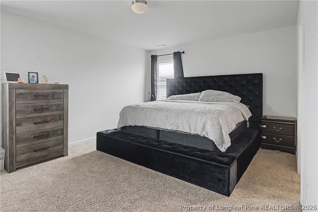 1717 Ennismore Road Hope Mills, NC 28348 - Photo 14 of 33 a bedroom with a bed and dresser