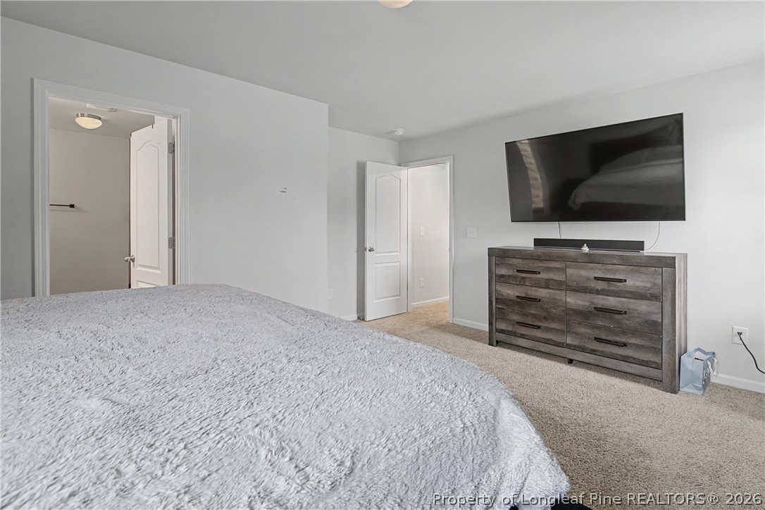 1717 Ennismore Road Hope Mills, NC 28348 - Photo 15 of 33 a bedroom with a bed and a television