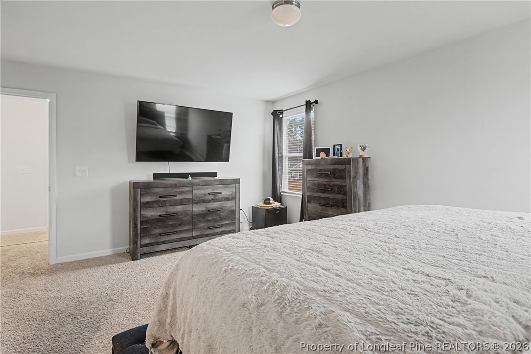 1717 Ennismore Road Hope Mills, NC 28348 - Photo 16 of 33 a bedroom with a bed and television