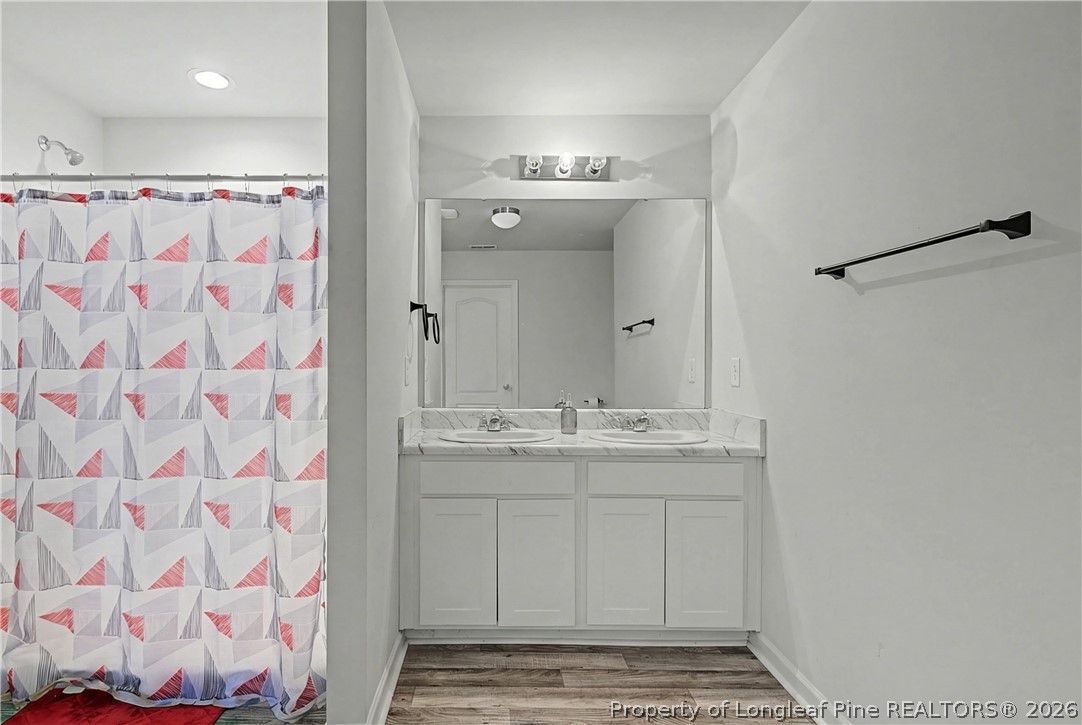 1717 Ennismore Road Hope Mills, NC 28348 - Photo 17 of 33 a bathroom with a sink and a mirror