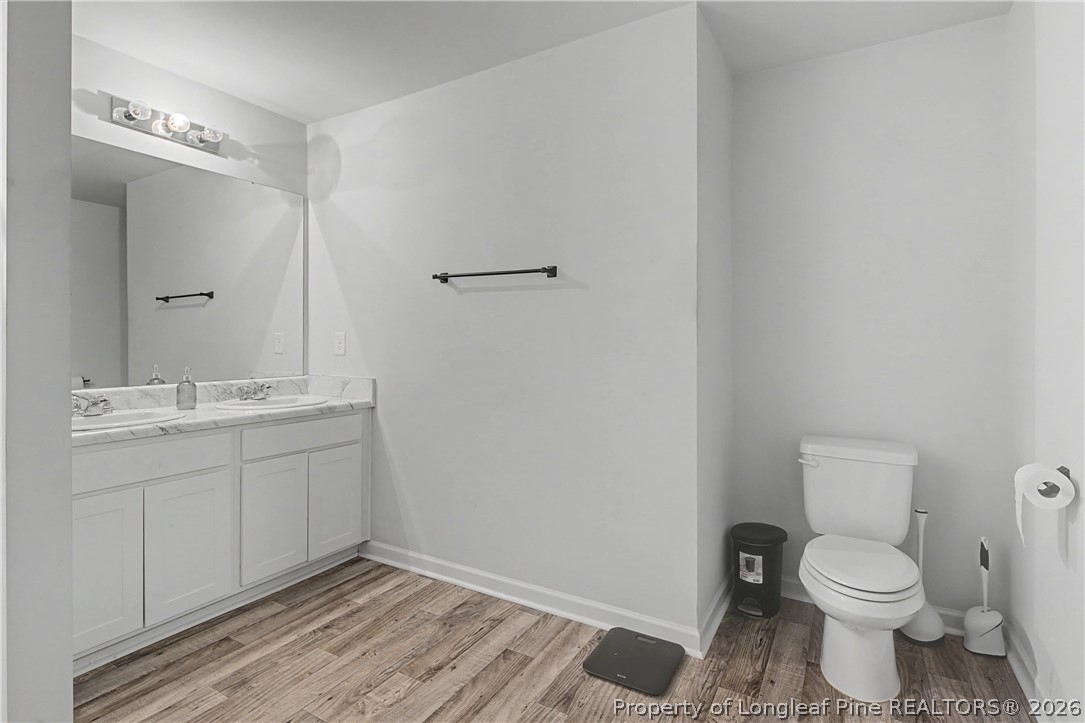 1717 Ennismore Road Hope Mills, NC 28348 - Photo 18 of 33 a bathroom with a sink toilet and vanity