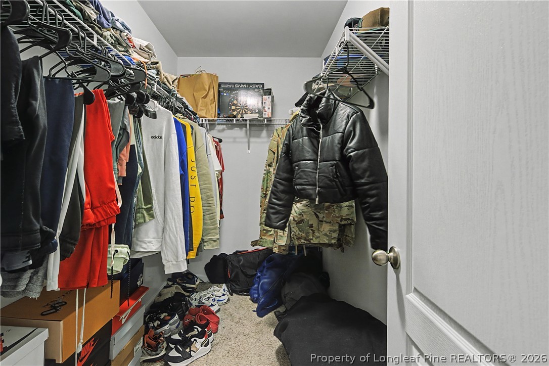 1717 Ennismore Road Hope Mills, NC 28348 - Photo 19 of 33 a view of walk in closet with clothes and shoes