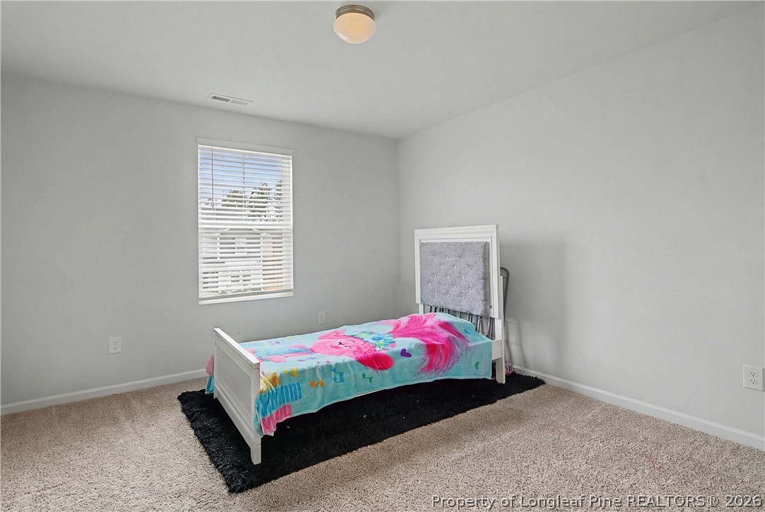 1717 Ennismore Road Hope Mills, NC 28348 - Photo 20 of 33 a bedroom with a bed and a window