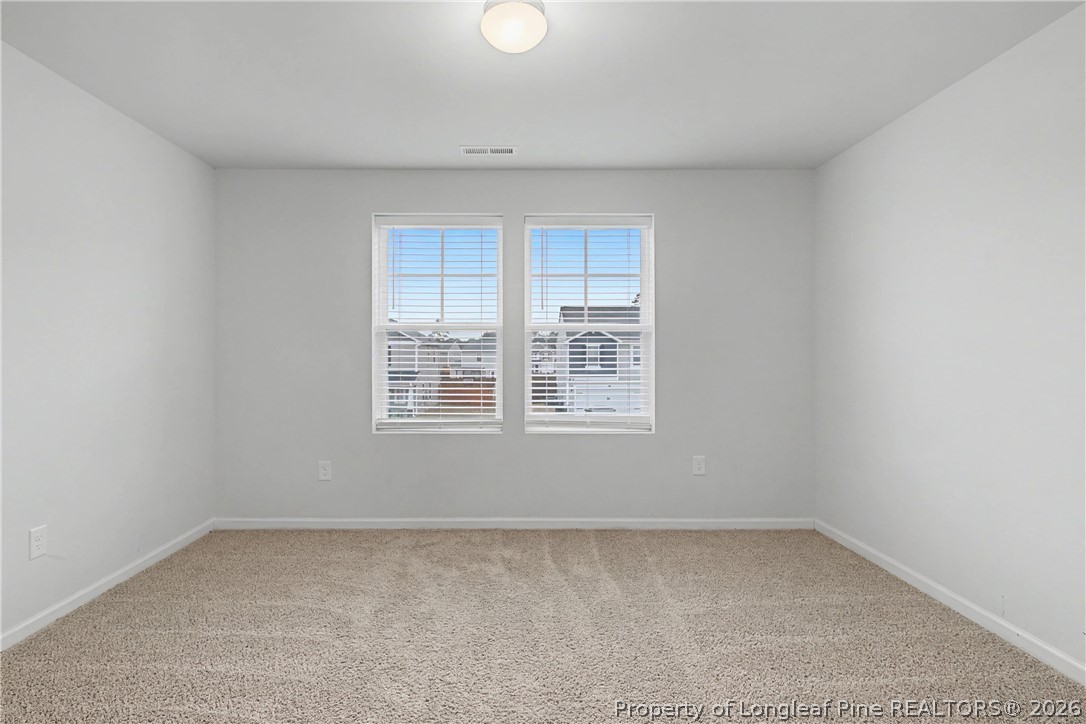 1717 Ennismore Road Hope Mills, NC 28348 - Photo 21 of 33 an empty room with a window
