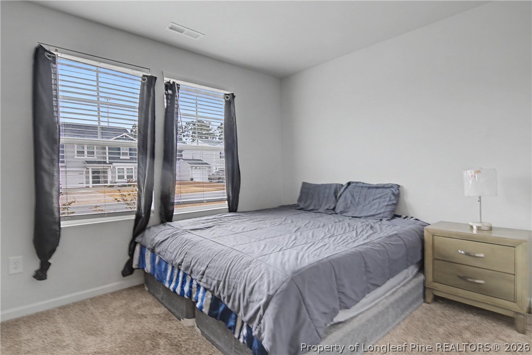 1717 Ennismore Road Hope Mills, NC 28348 - Photo 24 of 33 a bedroom with a bed and a window
