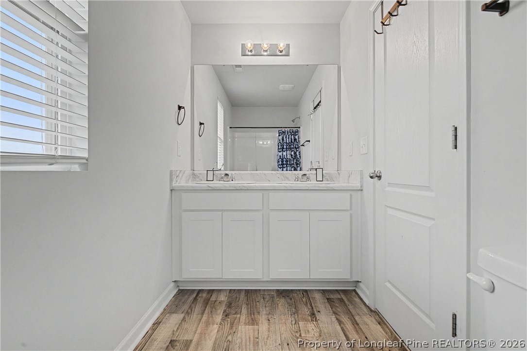 1717 Ennismore Road Hope Mills, NC 28348 - Photo 26 of 33 a bathroom with a sink and a mirror