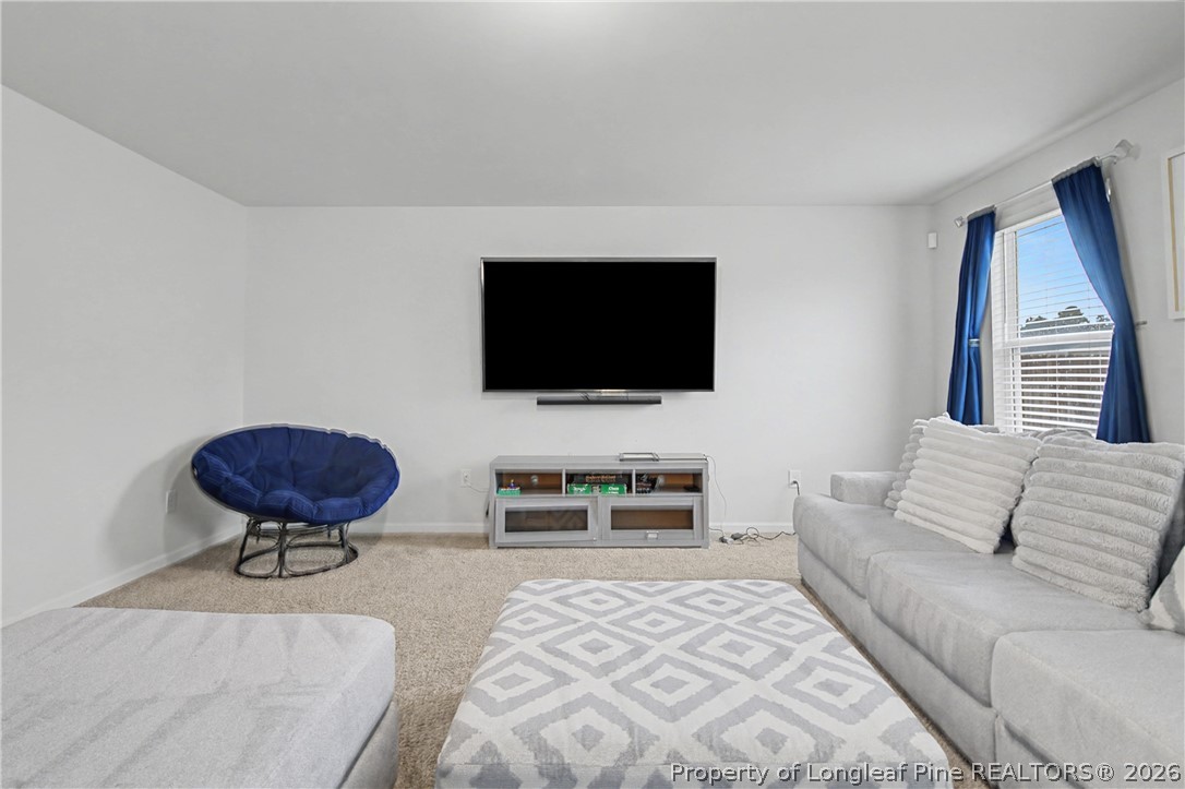 1717 Ennismore Road Hope Mills, NC 28348 - Photo 5 of 33 a living room with furniture and a flat screen tv