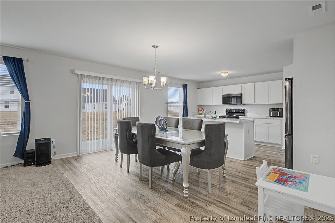 1717 Ennismore Road Hope Mills, NC 28348 - Photo 6 of 33 a view of a dining room with furniture and wooden floor