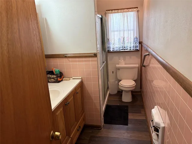 a bathroom with a sink a toilet and a window
