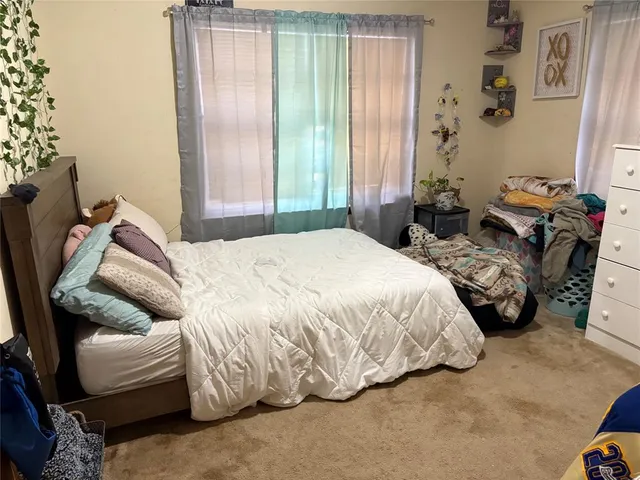 a bedroom with bed and a window