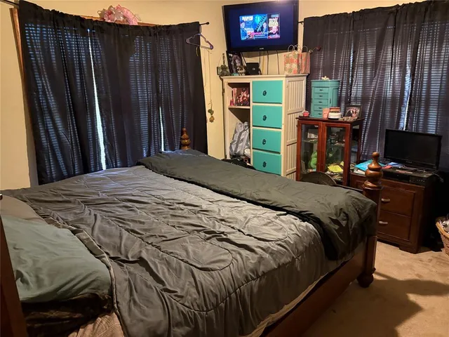 a bedroom with a bed and a bookshelf
