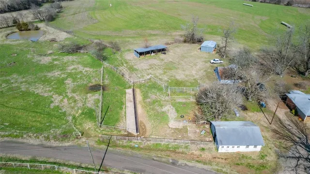 a aerial view of a residential houses with yard