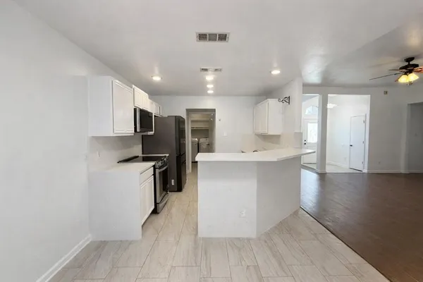 a kitchen with a refrigerator and a sink