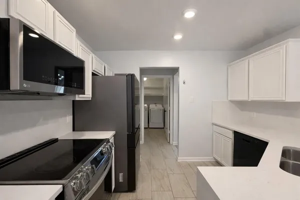 a kitchen with stainless steel appliances a refrigerator and a stove top oven