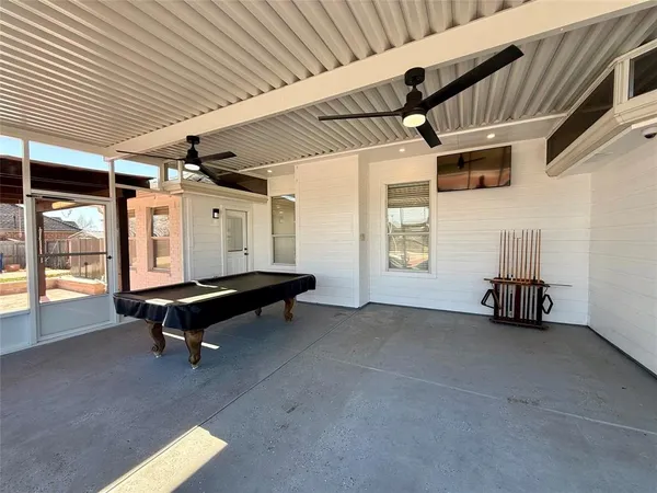 a backyard of a house with barbeque oven table and chairs