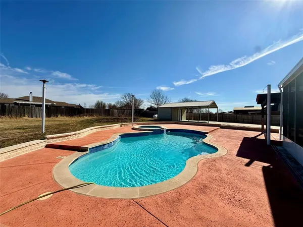 a view of a swimming pool with a yard