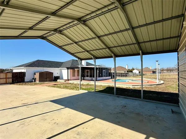 a view of a swimming pool with a patio