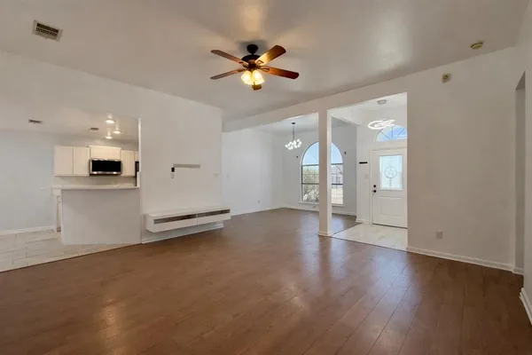 a view of an empty room with a kitchen