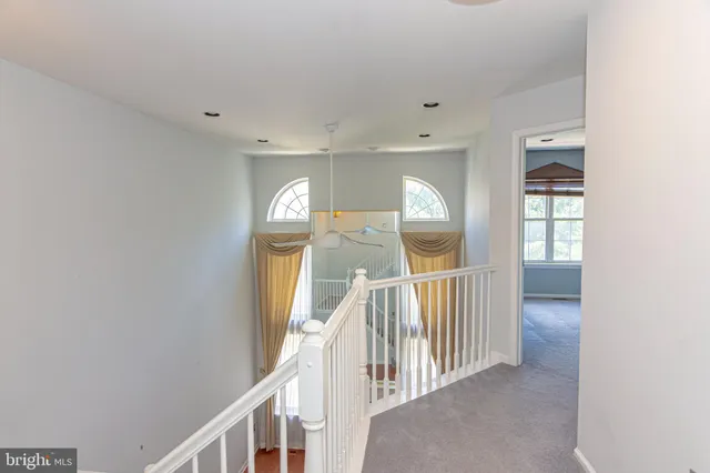 a view of staircase with railing and stairs