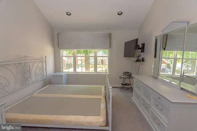 a bathroom with a bathtub a sink a window and a mirror