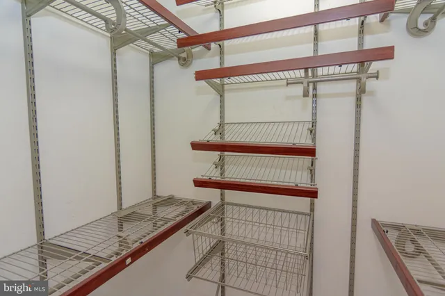 an empty room with windows and ceiling fan