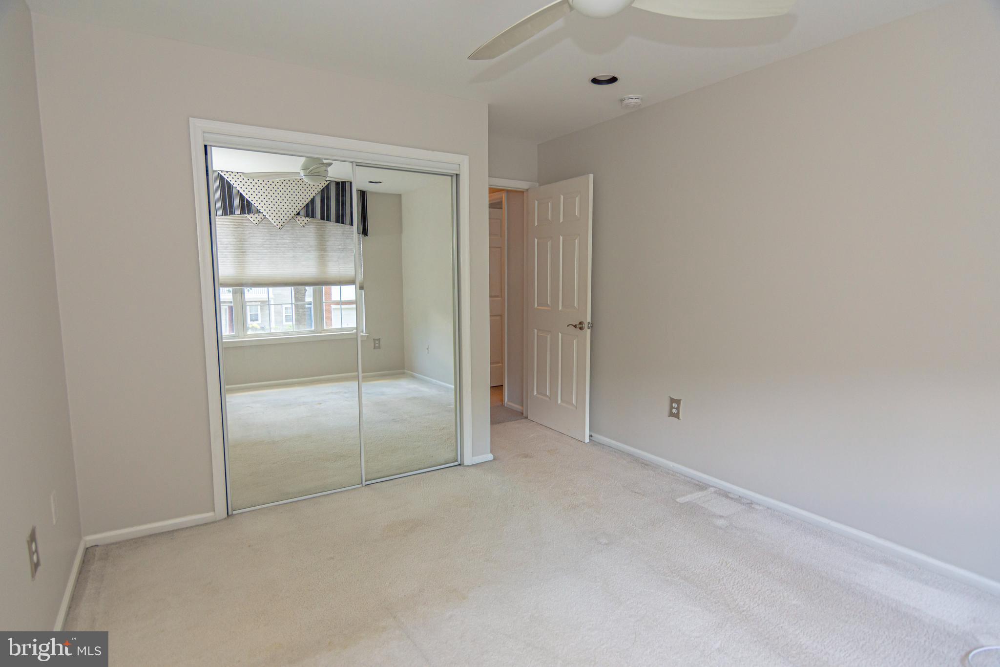 6 Howe Court Pennington, NJ 08534 - Photo 21 of 35 a view of an empty room with wooden floor and a window