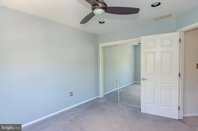a bathroom with a sink mirror vanity and toilet