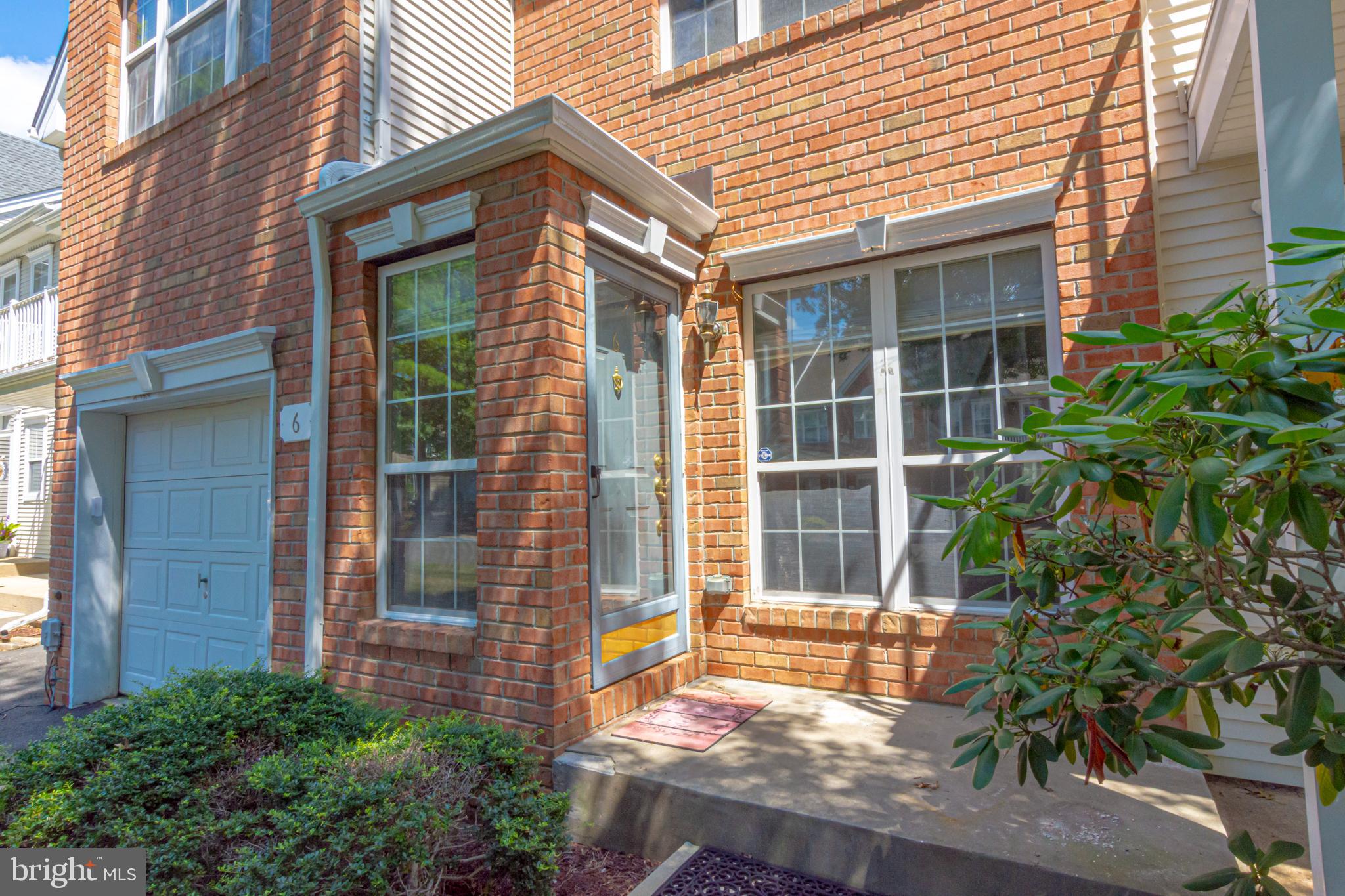 6 Howe Court Pennington, NJ 08534 - Photo 3 of 35 a view of a brick house with large windows and plants