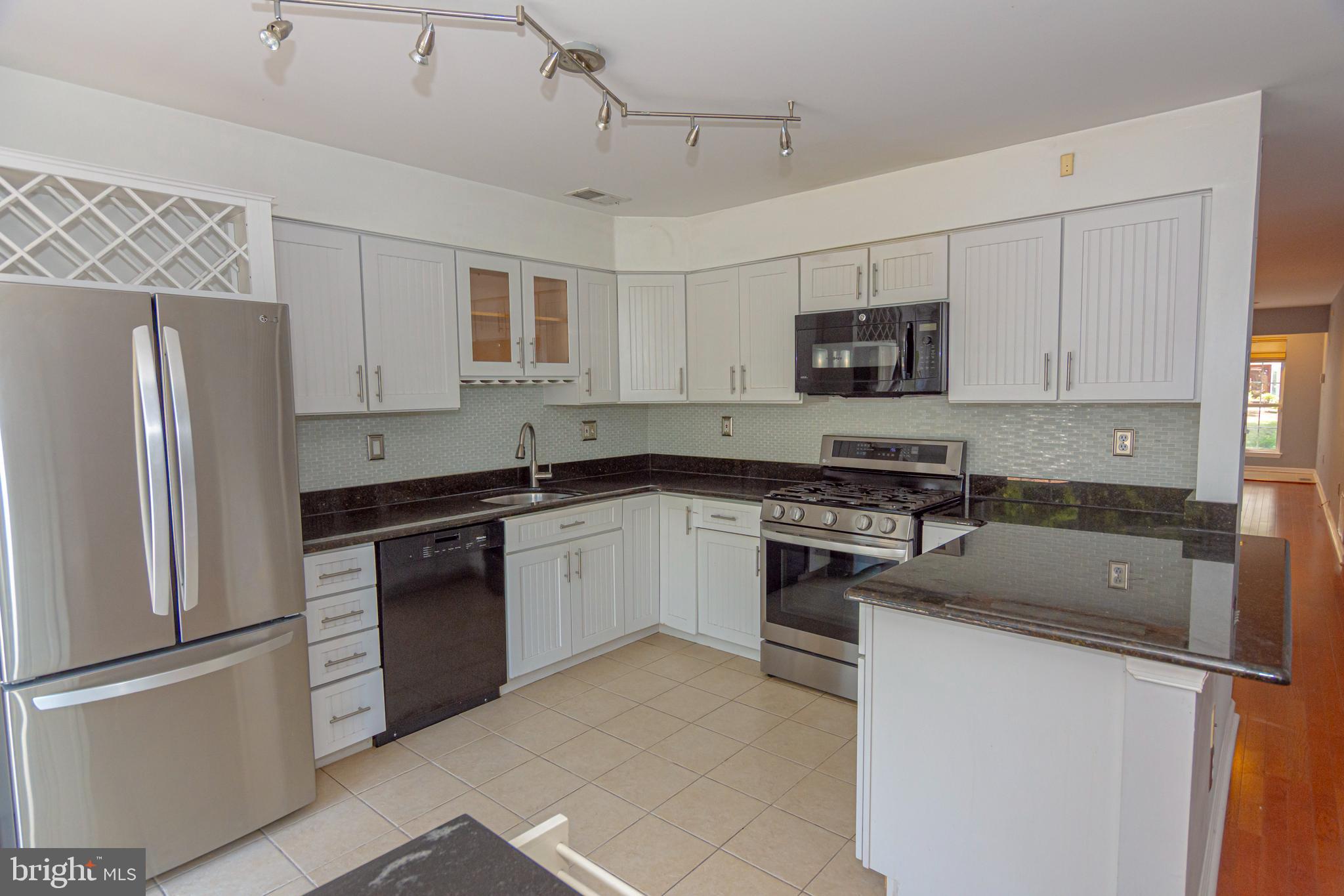 6 Howe Court Pennington, NJ 08534 - Photo 8 of 35 a kitchen with granite countertop a refrigerator stove top oven and sink