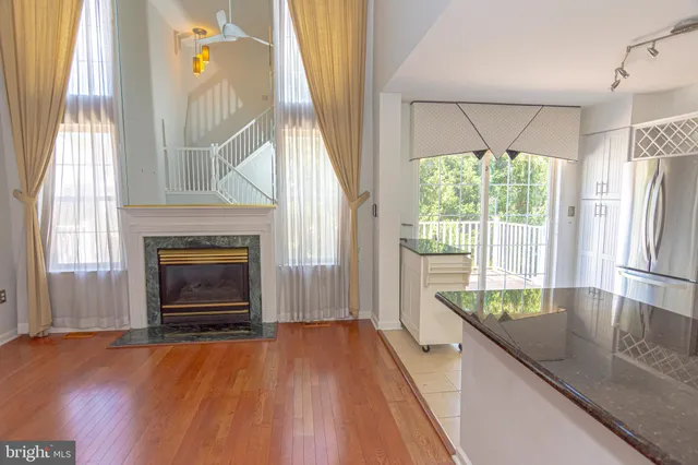 a kitchen with granite countertop a oven a fireplace a counter space and a window