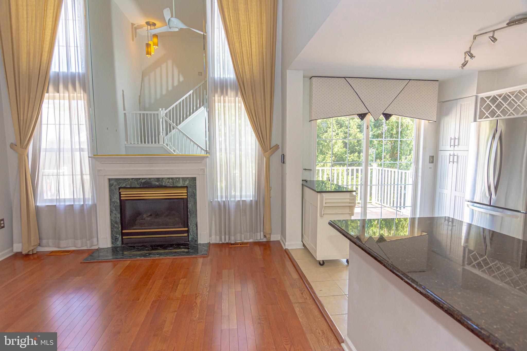 6 Howe Court Pennington, NJ 08534 - Photo 9 of 35 a kitchen with granite countertop a oven a fireplace a counter space and a window