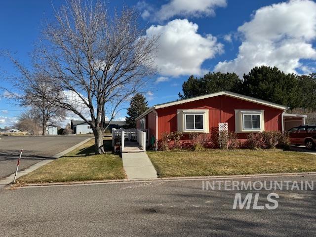 910 Moonglo, Unit 49 Buhl, ID 83316 - Photo 2 of 16 View of front of home with a front lawn