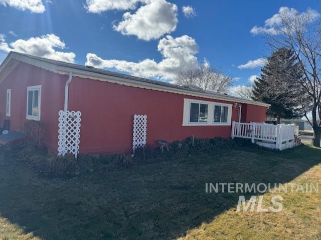 910 Moonglo, Unit 49 Buhl, ID 83316 - Photo 4 of 16 View of side of home with a yard and a deck