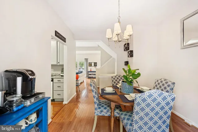 a living room with furniture flowerpot and wooden floor