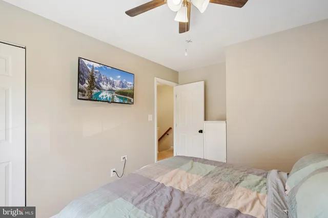 a bedroom with a bed and a painting on the wall