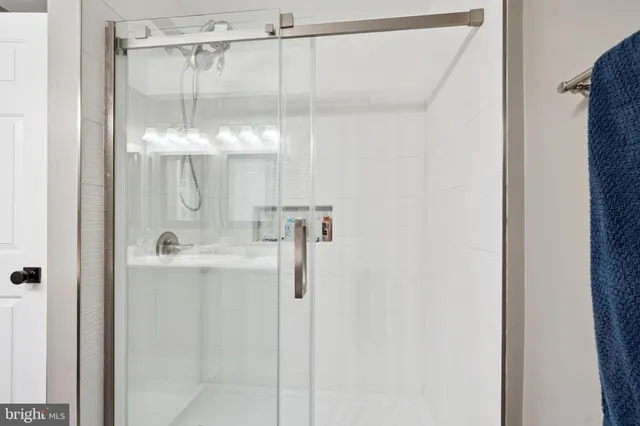 a bathroom with a glass shower door