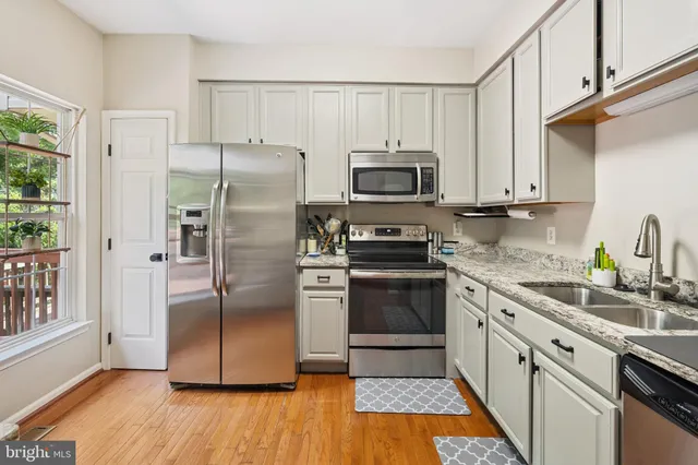 a kitchen with a refrigerator stove and microwave