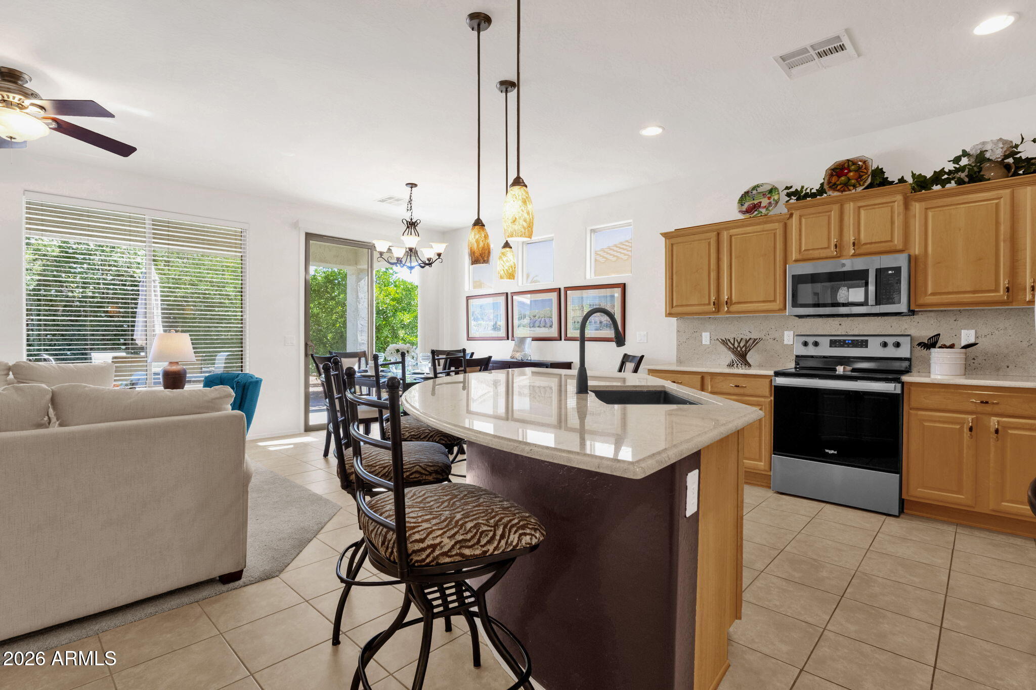 4094 East Azalea Drive Gilbert, AZ 85298 - Photo 11 of 21 a kitchen with stainless steel appliances granite countertop a sink a stove and a refrigerator